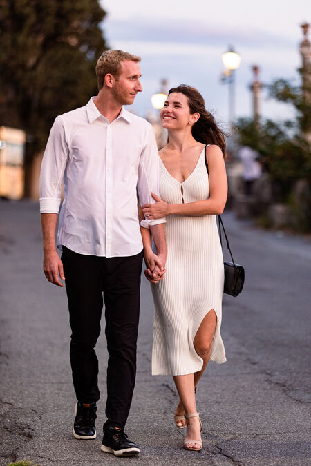 Happy newly-engaged couple walking hand in hand during their engagement photo session in Rome