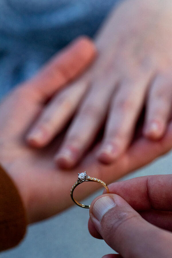 Close-up of the engagement ring in the hand of the newly-engaged fiancé