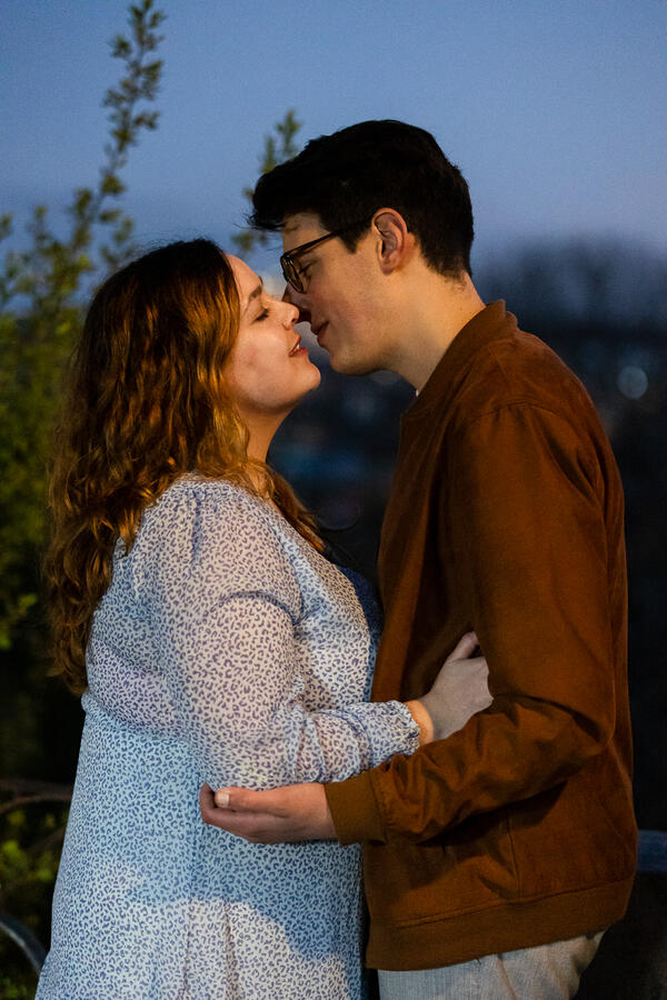 Newly-engaged couple kissing during their surprise marriage proposal in Rome