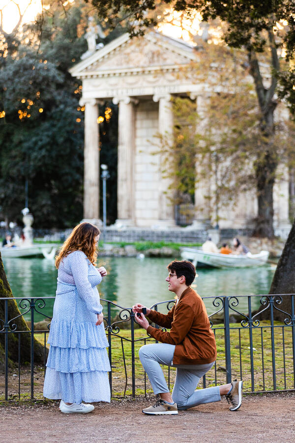 Surprise Wedding proposal by the lake in Villa Borghese with the Aesculapius temple in the bcakground