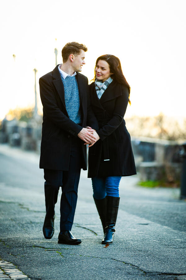 Happy newly-engaged couple walking on the Pincian Hill in the early hours of the morning during their surprise proposal photoshoot in Rome