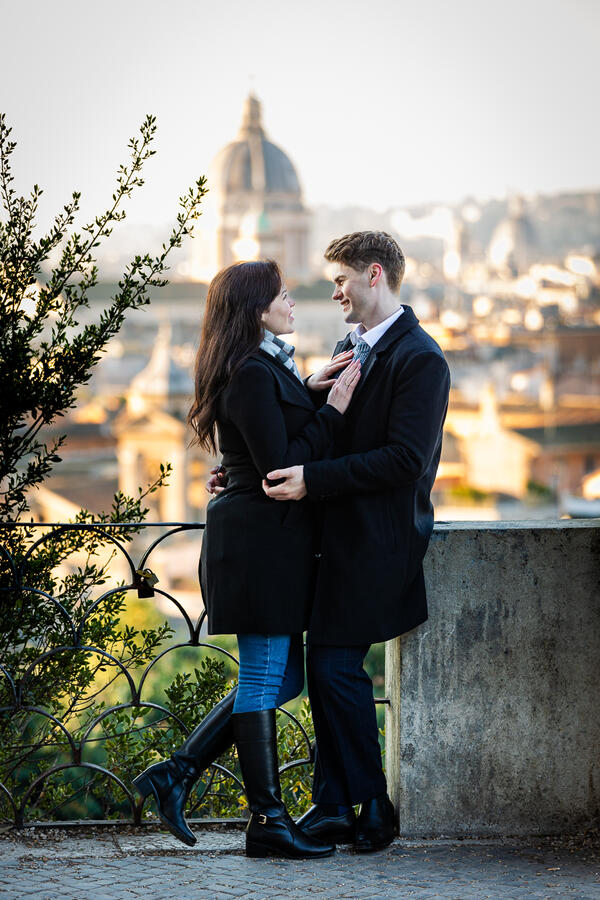 Newly-engaged couple holding each other on the Terrazza Belvedere in Rome