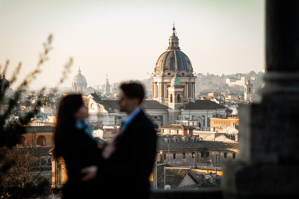 Beautiful couple holding each other with Rome in the background at sunrise