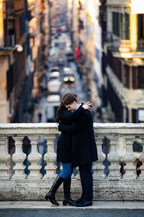 Newly-engaged couple holding each other romantically on the Spanish Steps in Rome