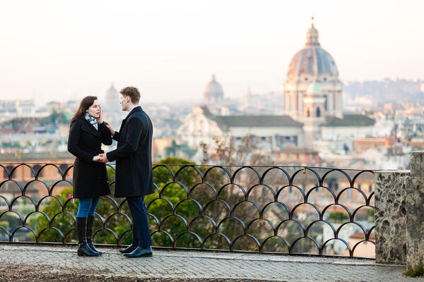 Man declaring his forever love to his girlfriend on Terrazza Belvedere at sunrise in Rome