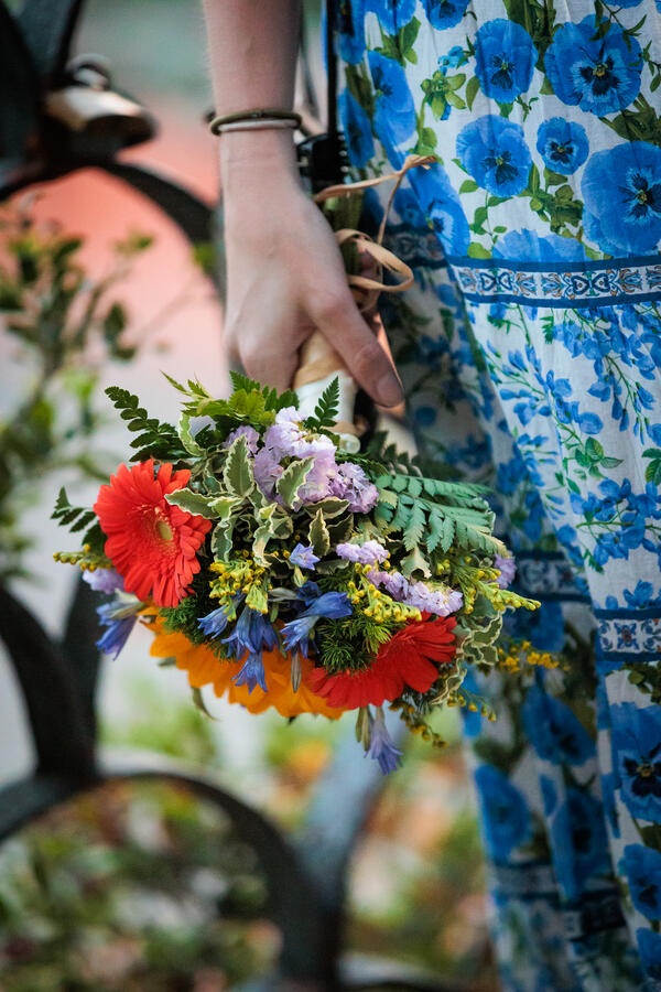 Fiancée holding a bouquet of flowers while on her surprise proposal photo shoot in Rome